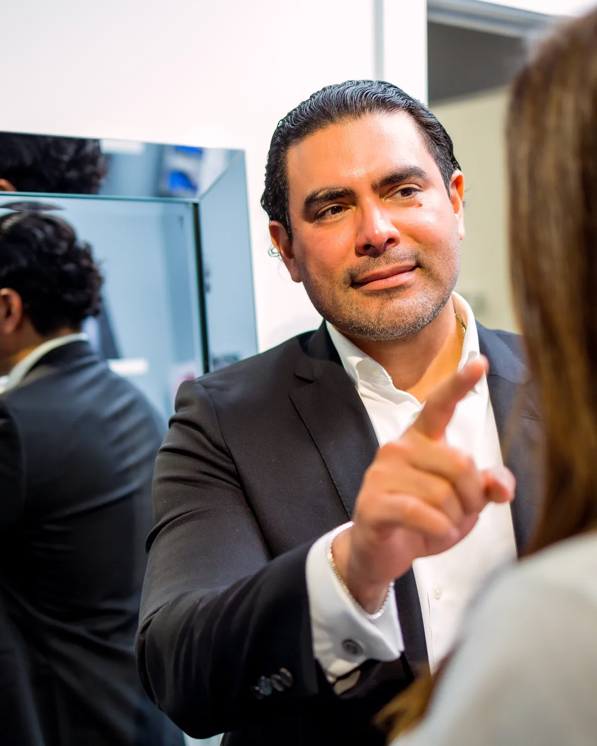 Dr. Roberto Ramirez Gavidia assessing breast position and support during a mastopexy consultation in Franklin, TN